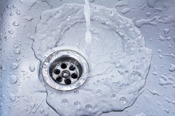 Clean clogged drain in a stainless steel sink